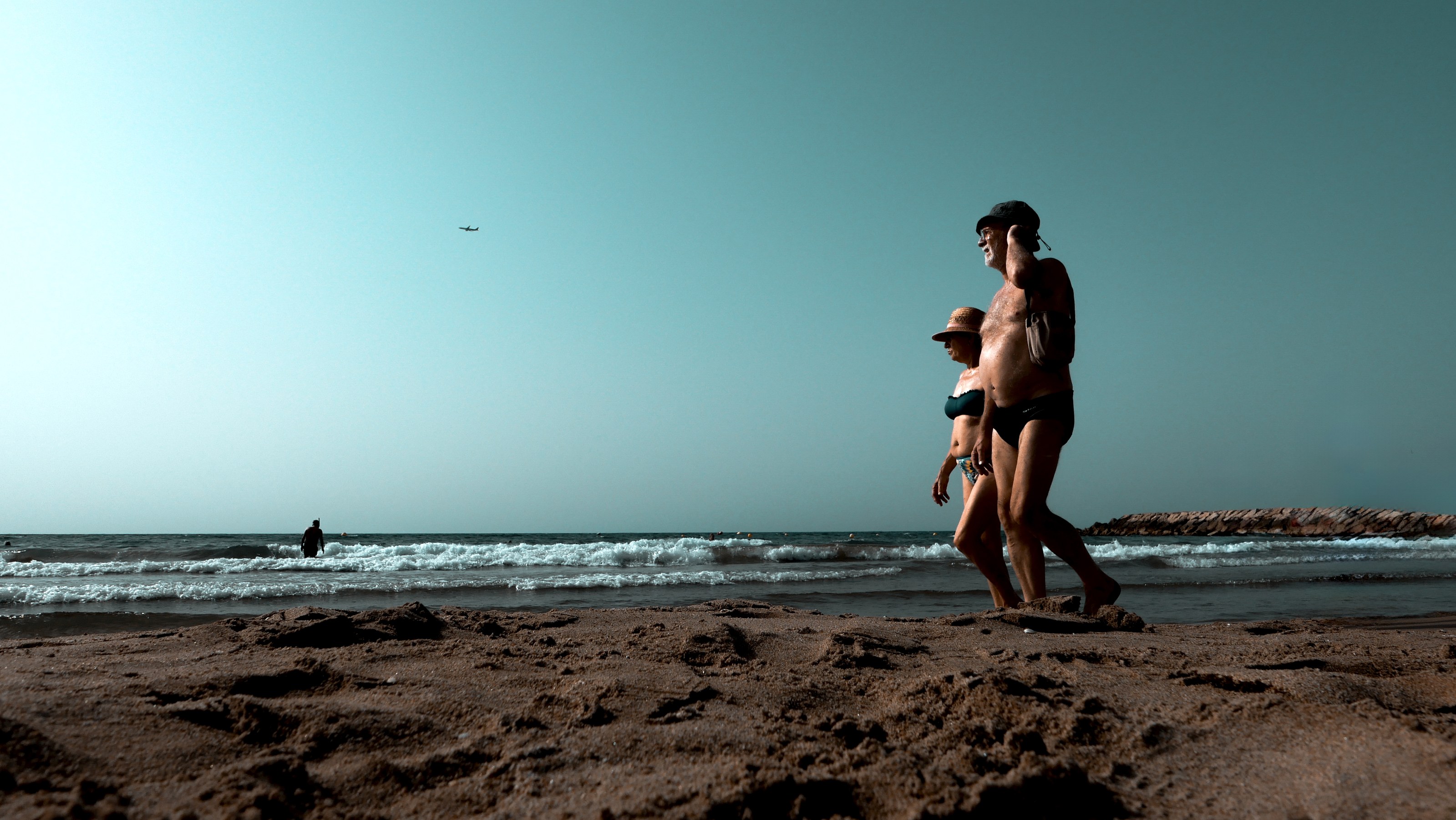 Elderly couple walking the shoreline