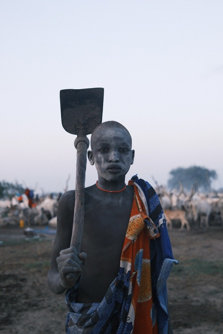 Boy with a spade, cattle camp